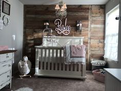 a baby's room with a crib and dresser