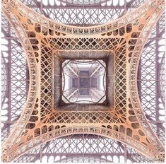 looking up at the top of the eiffel tower