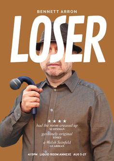 a man holding a microphone in front of his face with the words loser on it