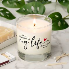 a candle that says, you light up my life with love always on it next to some matches