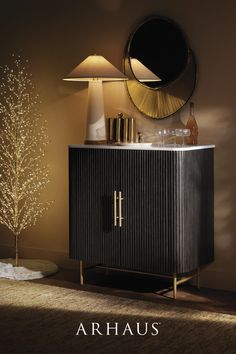 the cover of arhaus's latest catalogue, featuring an elegant cabinet and lamp