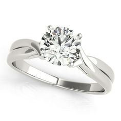 a white gold engagement ring with a round diamond in the center