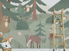 an animal themed children's room with forest wallpaper