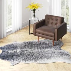 a brown chair sitting on top of a wooden floor next to a vase with yellow flowers