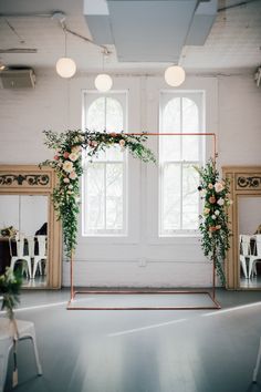 an empty room with mirrors and flowers on the wall