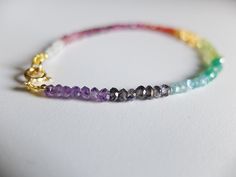 This rainbow bracelet has a great variety of natural gemstones. They are : Ruby, Iolite, Peridot, Citrine, Carnelian, Apatite , green Onyx , pink Tourmaline, Aquamarine and Apatite A gorgeous fusion of colors in this multi stone precious bracelet. A riot of vivid colors in ombre design I chose and lined the gemstones to obtain this unique shaded colorful precious bracelet. It will be beautiful alone or together with other gemstones stacking bracelets The gemstone beads are strung on the highest Multicolor Gemstone Beads, Multicolor Faceted Crystal Bracelet As Gift, Rainbow Gemstone Beads Bracelets For Jewelry Making, Multicolor Faceted Spiritual Bracelets, Multicolor Gemstone Rondelle Bracelets, Multicolor Faceted Gemstones For Healing, Spiritual Multicolor Faceted Beaded Bracelets, Rainbow Multi-stone Bracelets As A Gift, Multicolor Faceted Spiritual Gemstones