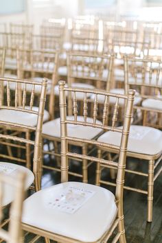 rows of gold chiavard chairs with white cushions