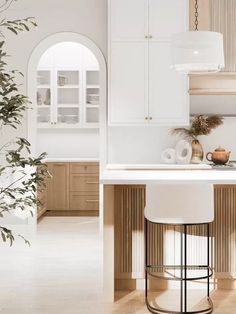 a white kitchen with an island and bar stools