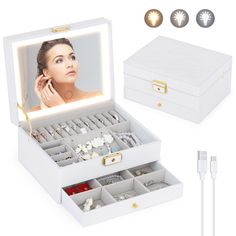 an open box with jewelry inside and earring holders on the side, next to it's contents