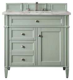 a green bathroom vanity with two sinks and no faucets on the counter top