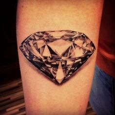 a black and white photo of a diamond tattoo