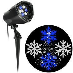 a blue and white snowflake light on top of a black pole