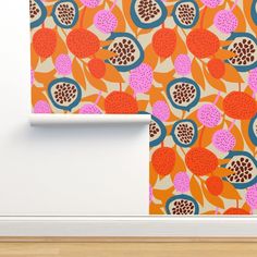 an orange wallpaper with pomegranates and leaves on it, next to a white door