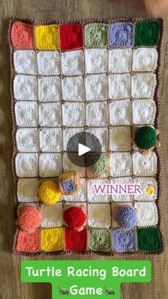 the turtle racing board game is made with crocheted squares and yarns, which are