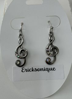 pair of earrings with musical notes and swarong crystal stones in the earwires