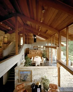 a living room filled with lots of furniture next to a fire place and staircase leading up to the second floor