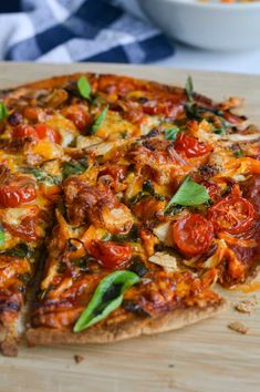 a pizza on a cutting board with one slice missing