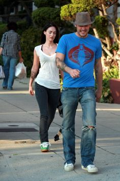 a man and woman walking down the street