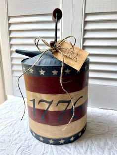 an american flag canister with a wooden stick sticking out of it's side