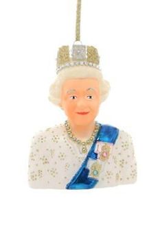 a glass ornament with a queen wearing a tiara and holding a blue ribbon