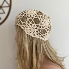 the back of a woman's head wearing a crocheted hat