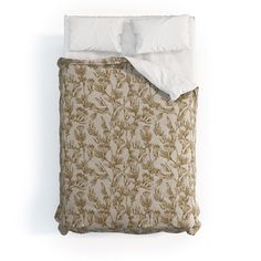 an image of a bed that is made up with white linens and brown leaves