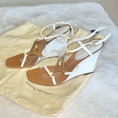 Great Used Condition Tan Leather & White Patent Leather Louis Vuitton Wedge Heels. Size 38. Adjustable Ankle Strap. Tan Leather Lv Logo On Top Of The Foot. The Only Flaw Is The Straps Are Yellowed. I Only Wore These Twice. Heel Measures 4”. Shoes Louis Vuitton, Lv Logo, Louis Vuitton Shoes, Womens Shoes Wedges, Wedge Heels, Tan Leather, Patent Leather, Ankle Strap, Wedges