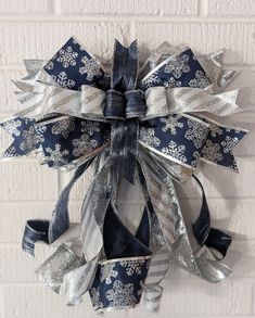 a blue and silver christmas wreath hanging on a brick wall