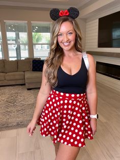 a woman in minnie mouse costume posing for the camera with her hand on her hip