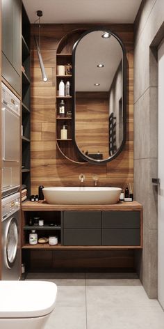 a washer and dryer in a bathroom with wood paneling on the walls