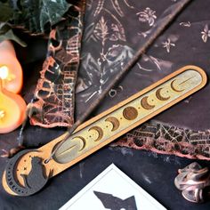 a wooden ruler sitting on top of a table next to some candles and other items