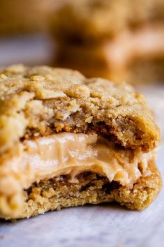 a cookie with peanut butter on it is cut in half to show the filling inside