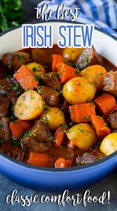 the best irish stew in a blue bowl with carrots and potatoes, on top of a table