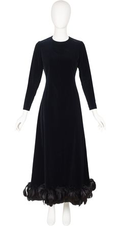 "This Givenchy Nouvelle Boutique long-sleeved evening gown is numbered, completely hand-finished demi-couture. It was made in France in the late-1960s/early-1970s of a black 78% cotton/22% viscose velvet blend, with a rayon lining and a feather trim hemline. It fastens at the back, and each cuff, with hand-set metal Eclair zippers. It's in overall very good condition. There are a few feathers missing but it's very discreet. Measurements:  Bust - 34\" Waist - 29\" Hips - 37\" Shoulders - 14\" Sle Formal Long Sleeve Fitted Evening Dress, Formal Fitted Long Sleeve Evening Dress, Long Sleeve Evening Dress For Fall Gala, Fall Long Sleeve Gala Evening Dress, Fall Long Sleeve Evening Dress For Gala, Cocktail Evening Dress With Long Sleeves And Fitted Bodice, Cocktail Evening Dress With Fitted Bodice And Long Sleeves, Long Sleeve Evening Dress With Fitted Bodice For Cocktail, Classic Evening Dresses For Winter