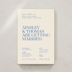 the front and back cover of an elegant wedding card with blue ink on white paper