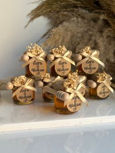 six honey jars with labels on them sitting on a table