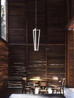 a table and chairs in a room with wooden walls