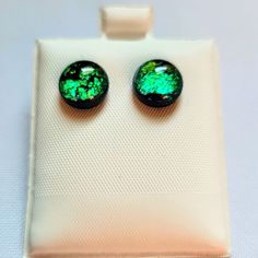 two green earrings sitting on top of a piece of white paper with the words, poshmark $ 20