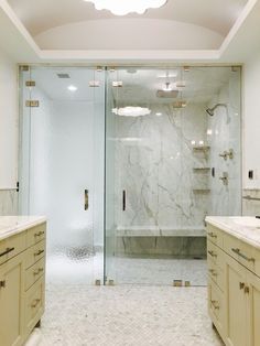 a large bathroom with two sinks and a walk in shower