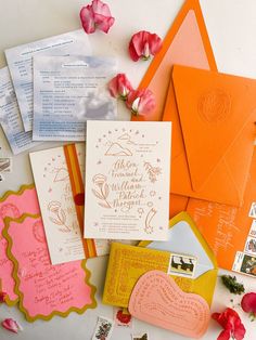 an assortment of wedding stationery items including envelopes, cards, and other decorations