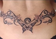 a woman's stomach with tattoos on it and flowers in the shape of butterflies