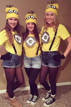 three girls dressed up in minion costumes