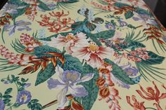 an image of a table cloth with flowers and birds on it's surface,