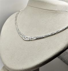 Buy a unique Handmade Ancient Greek Key Meander Silver Necklace For Women | Discover a large collection of Ancient Greek Jewelry in our ON-LINE shop | FREE SHIPPING all over the world This product is a beautiful silver 925 Necklace inspired by the Ancient Greek Key pattern-Meander.A meander or meandros (Greek: Μαίανδρος) is a decorative border constructed from a continuous line, shaped into a repeated motif. Such a design is also called the Greek fret or Greek key design. Visit my Home Page: https://www.etsy.com/shop/GreekHistoryArt Type We offer 1 type of necklace  Size Length:Adjustable Width:0.8cm(0.32 inches) IF YOU WANT OTHER SIZE PLEASE CONTACT US Material All my products are pure Sterling Silver. This necklace is Shiny Silver and degrade. If you wish to see more products with Meande Classic Silver Engraved Necklace, Classic Silver Necklace Stamped 925, Classic Handmade Silver Necklaces, Classic White Gold Necklace Stamped 925, Silver Engraved Necklace Fine Jewelry, Fine Jewelry Silver Engraved Necklace, Classic Sterling Silver Necklace Stamped 925, Silver Necklace With Sterling Silver Clasp For Anniversary, Engraved Silver Necklace Fine Jewelry