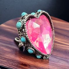 Add some extra sparkle to your look with this pink glass rhinestone ring featuring faux turquoise accents. The adjustable cuff style makes it a perfect fit for anyone. Painted Hats, Silver Chain For Men, Buckles Fashion, Turquoise Accents, Rhinestone Ring, Stone Heart, Pendant Bracelet, Pink Glass, Chains For Men