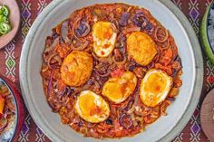 an overhead view of some food in a bowl on a table with other dishes around it