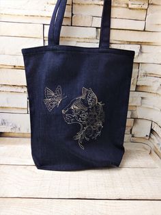 Denim tote bag with fashionable embroidery is sewn from high-quality fabric . High quality and stylish bag roomy enough and comfortable. This bag is designed to complement your unique look. The bag measures approximately:  1) 34 cm (13 inches) high, 32 cm (12.5 inches) wide and 9 cm (3.5 inches) deep;  2) 37cm (14.5 inches) high , 35 cm (13,7 inches) wide  and 10 cm (4 inches) deep; 3)40cm (16 inches) high , 38 cm (15 inches) wide  and 10 cm (4 inches) deep.   Double straps are made from the sam Bag With Embroidery, Embroidered Tote Bag, Embroidered Tote, Bleach Art, Denim Tote Bags, Denim Tote, Book Bag, Reusable Grocery Bags, Everyday Carry