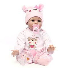 a baby doll with a pacifier in its mouth sitting next to a pink and blue background