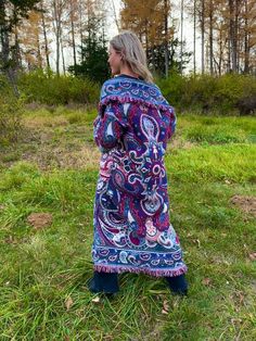 "Introducing my latest creation! Took two beautiful vintage woven afghan tapestries and upcycled them into a cozy, one of a kind maxi length blanket coat.  Double front pockets and toggle closure for added functionality. Features gorgeous navy, maroon, and cream paisley print. Dreamy, boho wanderlust vibes. Sure to turn heads wherever you may roam. Measurements: Overall length: 55\" Pit to pit laying flat: 23\" Shoulder seam to wrist: 22\" 100% cotton. Machine wash, tumble dry on low heat. This Bohemian Jacquard Knit Outerwear For Fall, Fall Bohemian Outerwear With Paisley Print, Bohemian Fall Outerwear With Paisley Print, Fall Bohemian Paisley Print Outerwear, Bohemian Multicolor Wool Outerwear, Multicolor Bohemian Outerwear With Paisley Print, Bohemian Multicolor Paisley Print Outerwear, Blue Bohemian Sweater Coat, Blanket Coat