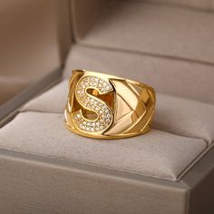 This elegant ring for any occasion features a large blocky signet design with a high-quality stainless steel construction and gold color finish. Its adjustable one-size-fits-all design makes it perfect for both men and women, and the unique A-Z choose your own letter initial allows for personalized representation. Perfect for gifting, this timeless jewelry is sure to make a statement. Harry Styles Rings, Gold Initial Ring, Letter Ring, Gold Ring Designs, Couple Jewelry, Chunky Rings, Initial Ring, Gold Initial, Platinum Metal